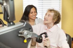 A physical therapist helping an elderly woman at Lincoln Meadows