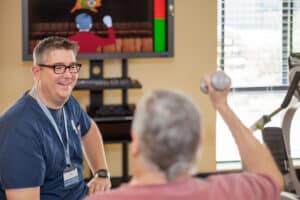 A physical therapist helping a man at Lincoln Meadows