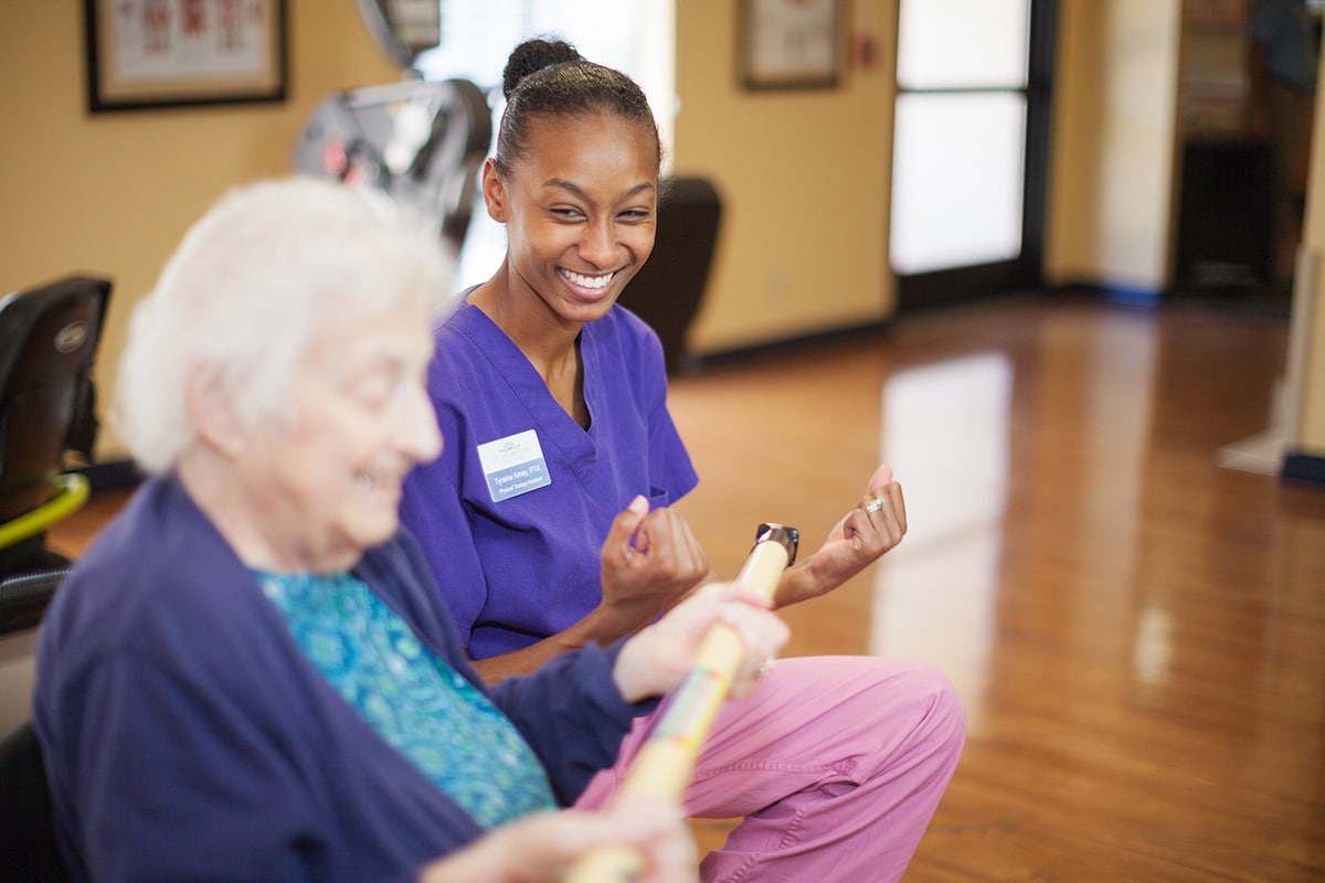 Physical therapist helping an elderly woman at Lincoln Meadows