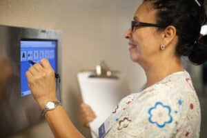 A nurse putting information into a computer at Lincoln Meadows