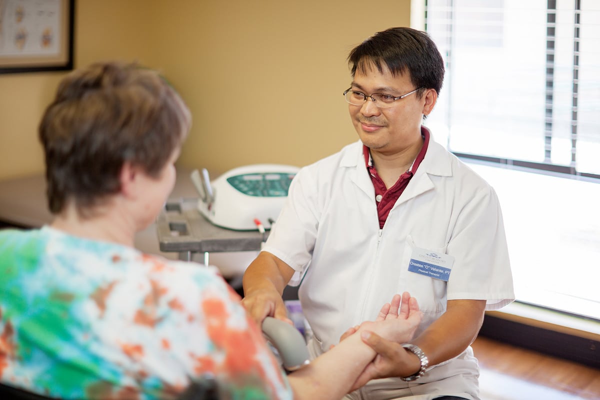 A nurse helping an elderly woman at Lincoln Meadows